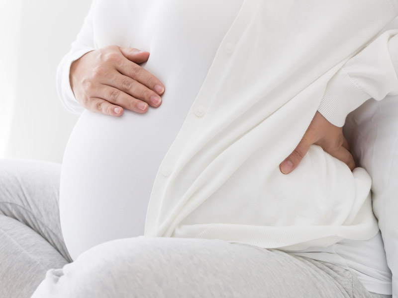 pregnant woman holding stomach