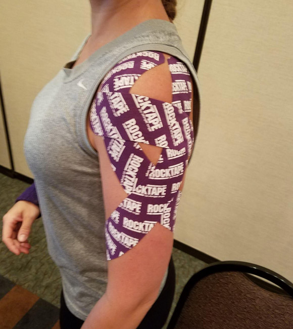 woman with rocktape on her shoulder